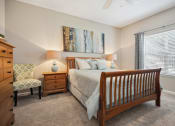 Thumbnail 2 of 46 - a bedroom with a bed and a chair and a window