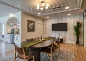 Thumbnail 23 of 40 - A modern dining room with a large table and chairs.