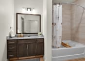 Thumbnail 8 of 35 - a bathroom with a tub and a sink and a mirror at The Enclave at Deer Moss Creek, Niceville, FL