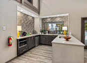 Thumbnail 49 of 67 - A modern kitchen with a large island and a fire extinguisher on the wall.