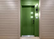 Thumbnail 9 of 44 - A green door with a black handle and a round doorknob.