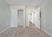 Thumbnail 20 of 28 - A room with a carpeted floor and white walls.