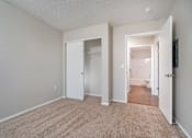 Thumbnail 12 of 28 - A room with carpeted floor and white walls.