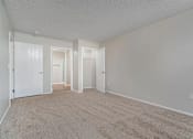 Thumbnail 14 of 28 - A room with carpeted floor and white walls.