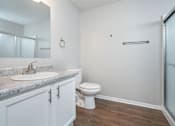 Thumbnail 22 of 28 - A bathroom with a sink, toilet, and a shower.