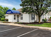 Thumbnail 27 of 28 - A white building with a blue awning that says Alkire Gate Rental Office.