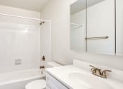 Thumbnail 9 of 36 - a white bathroom with a tub sink and mirror