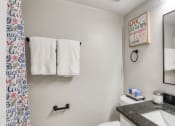 Thumbnail 29 of 52 - a bathroom with a sink and a mirror and a toilet  at Bayville Apartments, Virginia Beach, VA