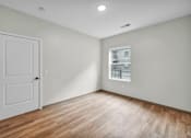 Thumbnail 13 of 27 - A room with a white door and a window with blinds.