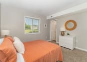 Thumbnail 13 of 43 - a bedroom with an orange bed and a window at Village 1373, Greensboro