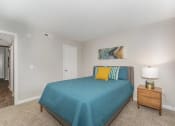 Thumbnail 11 of 43 - a bedroom with a bed and a night stand at Village 1373, Greensboro, 27455
