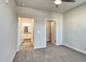 Thumbnail 10 of 42 - an empty living room with white walls and a ceiling fan at The Bella at Westchester, Midlothian, VA, 23113