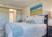 Thumbnail 10 of 15 - a bedroom with a large bed and a painting