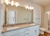 Thumbnail 9 of 42 - a bathroom with two sinks and a shower and a toilet at The Bella at Westchester, Virginia