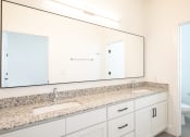 Thumbnail 27 of 81 - a bathroom with a large mirror and two sinks at Ainsworth, Richmond, VA