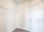 Thumbnail 16 of 42 - a walk in closet with white walls and shelves and a window at The Bella at Westchester, Midlothian, VA, 23113