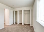 Thumbnail 7 of 36 - an empty bedroom with closet doors and a window