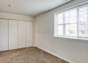 Thumbnail 11 of 36 - an empty bedroom with two closets and a window