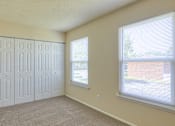 Thumbnail 12 of 26 - A room with a white door and a window with blinds.