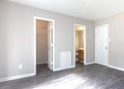 Thumbnail 6 of 31 - A room with two doors and a wooden floor.