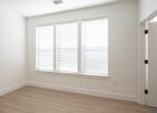 Thumbnail 34 of 81 - a bedroom with white walls and a wooden floor at Ainsworth, Richmond, VA