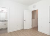 Thumbnail 32 of 81 - a bedroom with white walls and hardwood floors at Ainsworth, Richmond, VA