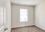 Thumbnail 13 of 36 - an empty bedroom with white walls and a window