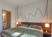 Thumbnail 26 of 53 - a bedroom with a bed and a line drawing on the wall above itThe View at Blue Ridge Commons Apartments, Virginia, 24017