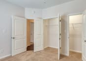 Thumbnail 29 of 35 - an empty bedroom with three closets and three doors