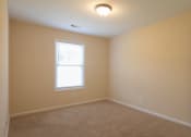 Thumbnail 6 of 21 - a bedroom with a white door and a window