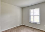 Thumbnail 12 of 36 - an empty bedroom with white walls and a window