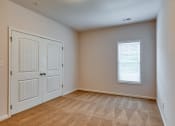 Thumbnail 28 of 35 - an empty living room with two doors and a window