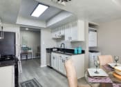 Thumbnail 23 of 52 - a kitchen and dining room with a table and chairs  at Bayville Apartments, Virginia Beach, 23455