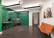 Thumbnail 14 of 39 - A room with a green wall and a wooden bench.