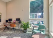 Thumbnail 16 of 53 - an office with a desk and chairs and a windowat Blue Ridge Commons Apartments, Virginia, 24017