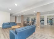Thumbnail 25 of 43 - a living room with blue couches and a table at Village 1373, Greensboro, 27455