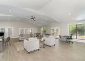 Thumbnail 26 of 43 - a living room with couches and chairs and a ceiling fan at Village 1373, Greensboro, NC 27455