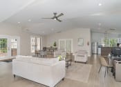 Thumbnail 22 of 43 - a living room with a white couch and a ceiling fan at Village 1373, North Carolina