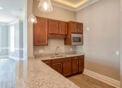 Thumbnail 9 of 35 - Clubhouse Kitchen at Logans Landing Apartments in Lynchburg VA