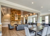 Thumbnail 3 of 35 - the gathering room has a large stone fireplace and a table with chairs