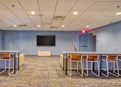 Thumbnail 28 of 33 - A conference room with a large table and chairs.