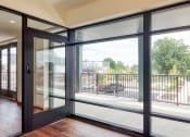 Thumbnail 15 of 81 - the view from the living room of a condo with glass doors and a balcony at Ainsworth, Virginia, 23228