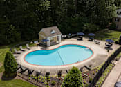 Thumbnail 25 of 40 - A small house with a pool in the backyard.