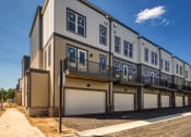 Thumbnail 41 of 81 - a row of townhomes on a sunny day with trees in the background at Ainsworth, Richmond
