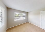 Thumbnail 37 of 40 - a bedroom with a large window and a white door
