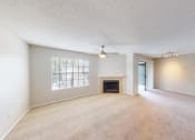 Thumbnail 34 of 40 - an empty living room with a fireplace