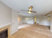 Thumbnail 36 of 40 - a living room with a fireplace and a ceiling fan