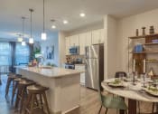 Thumbnail 27 of 53 - an open kitchen and dining area with a table and chairsat Blue Ridge Commons Apartments, Roanoke, Virginia