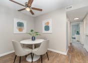 Thumbnail 4 of 43 - a dining room with a table and chairs and a ceiling fan at Village 1373, Greensboro, NC 27455