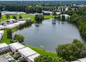 Thumbnail 26 of 28 - A large lake surrounded by buildings and trees.